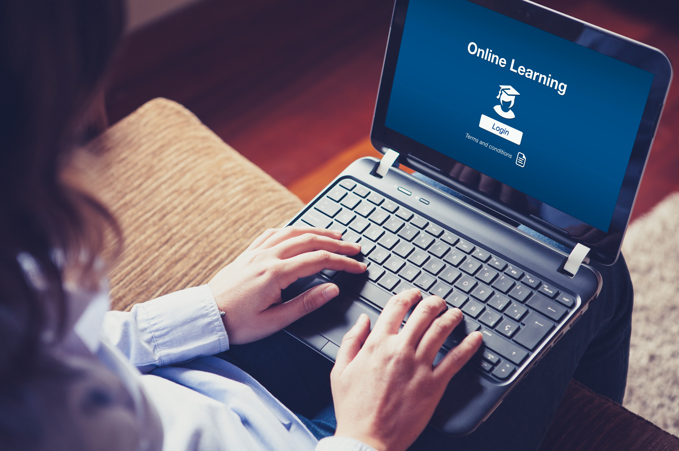 Learner completing an online business training course on a laptop